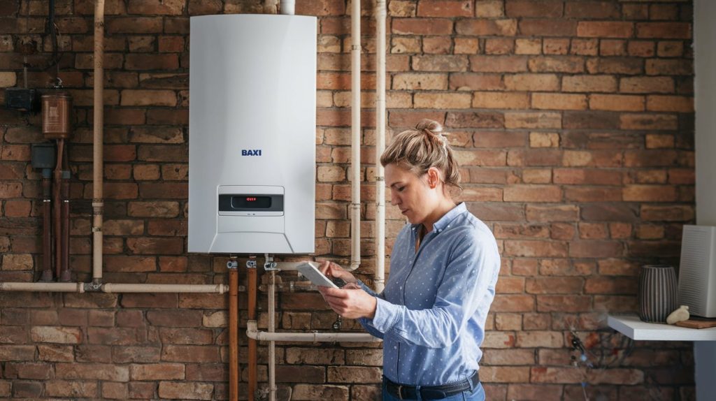 wall-mounted-baxi-combination-boiler-in-uk-home-6HYrwCWKSIq0XHlPRJe4AQ-sOJFhQbDTRao4McH-0N_Zw a woman looking at a tablet